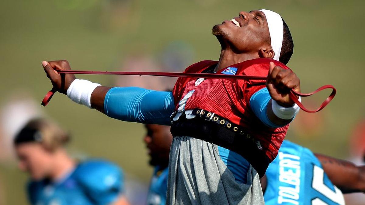 Carolina Panthers quarterback Cam Newton basks in the morning sun as he stretches with his teammates during practice at Wofford College in Spartanburg, SC on August 1, 2016.