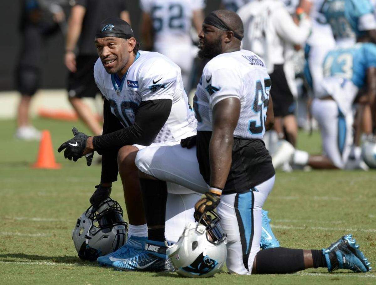 Carolina Panthers defensive end Julius Peppers, left, says “... it’s been nice for me to watch (defensive end Charles Johnson, right) from afar grow up and develop into one of the team leaders, develop as a person and as a grown man.”