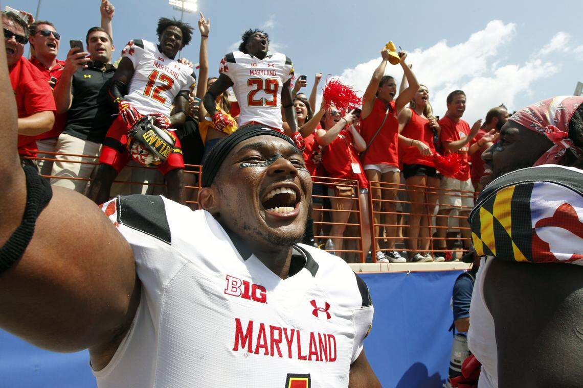 Maryland's Jermaine Carter, Jr. front, celebrates with teammates and fans after defeating Texas in an NCAA college football game, Saturday, Sept. 2, 2017, in Austin, Texas. Maryland won 51-41. (AP Photo/Michael Thomas)