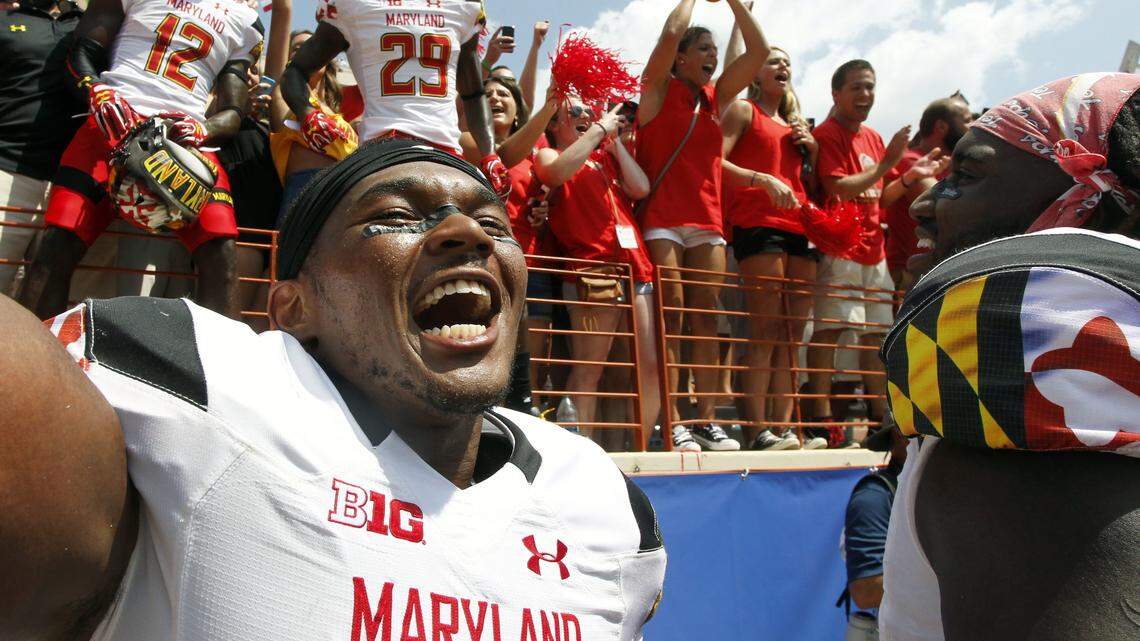 Maryland's Jermaine Carter, Jr. front, celebrates with teammates and fans after defeating Texas in an NCAA college football game, Saturday, Sept. 2, 2017, in Austin, Texas. Maryland won 51-41. (AP Photo/Michael Thomas)