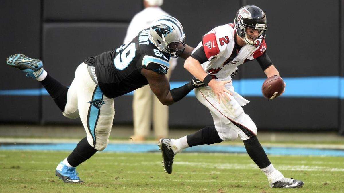 Carolina Panthers defensive tackle Kawann Short (99) reels in Atlanta Falcons quarterback Matt Ryan (2) for a sack and fumble in the third quarter at Bank of America Stadium on Sunday. The Panthers won 38-0.