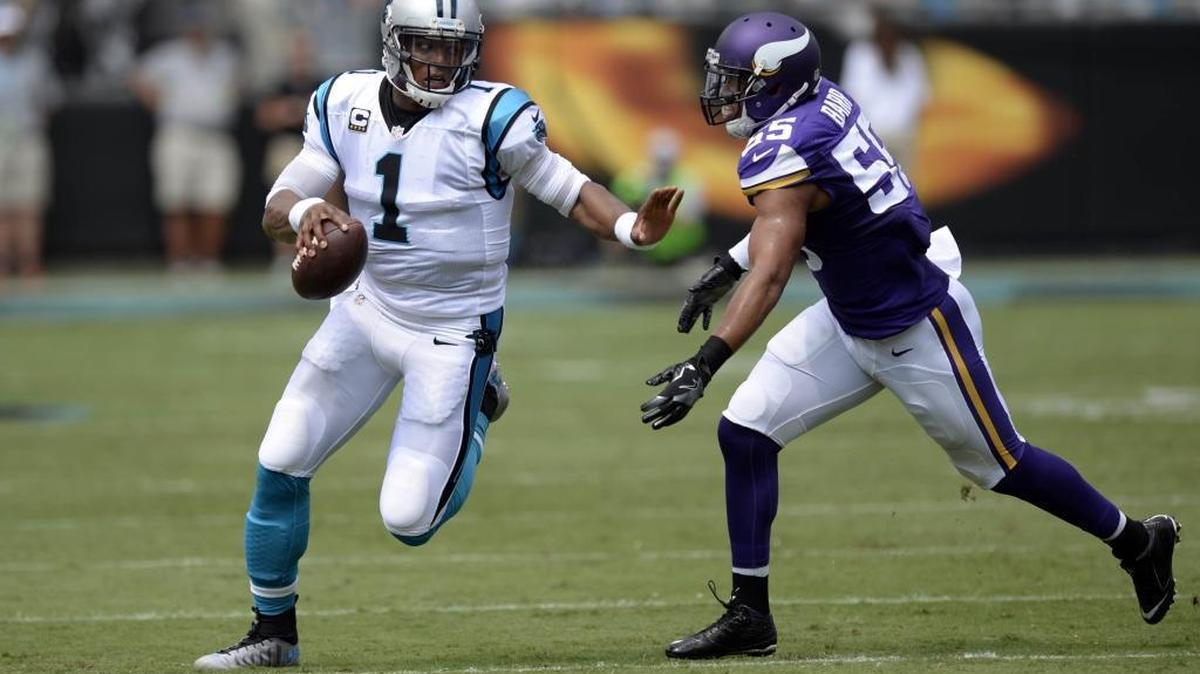Carolina Panthers quarterback Cam Newton (1) fends off Minnesota Vikings outside linebacker Anthony Barr (55) while running upfield in the first half at Bank of America Stadium on Sunday.