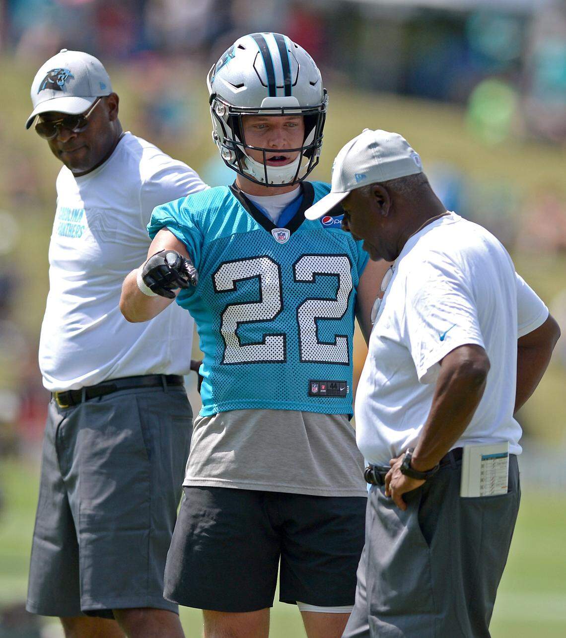 Carolina Panthers running back Christian McCaffrey, center, talks with running backs coach Jim Skipper, right, during the team’s second training camp practice on Friday, July 27, 2018. The Panthers are holding training camp at Wofford College in Spartanburg, SC.