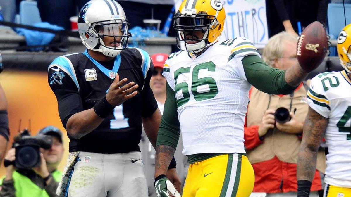 Green Bay Packers' Julius Peppers (56) plays keep-away with the ball, eventually throwing it away, as Carolina Panthers' Cam Newton (1) reaches for while celebrating a Panthers touchdown during the second quarter at Bank of America Stadium on Sunday, November 8, 2015. The Panthers won 37-29, and improve to 8-0.