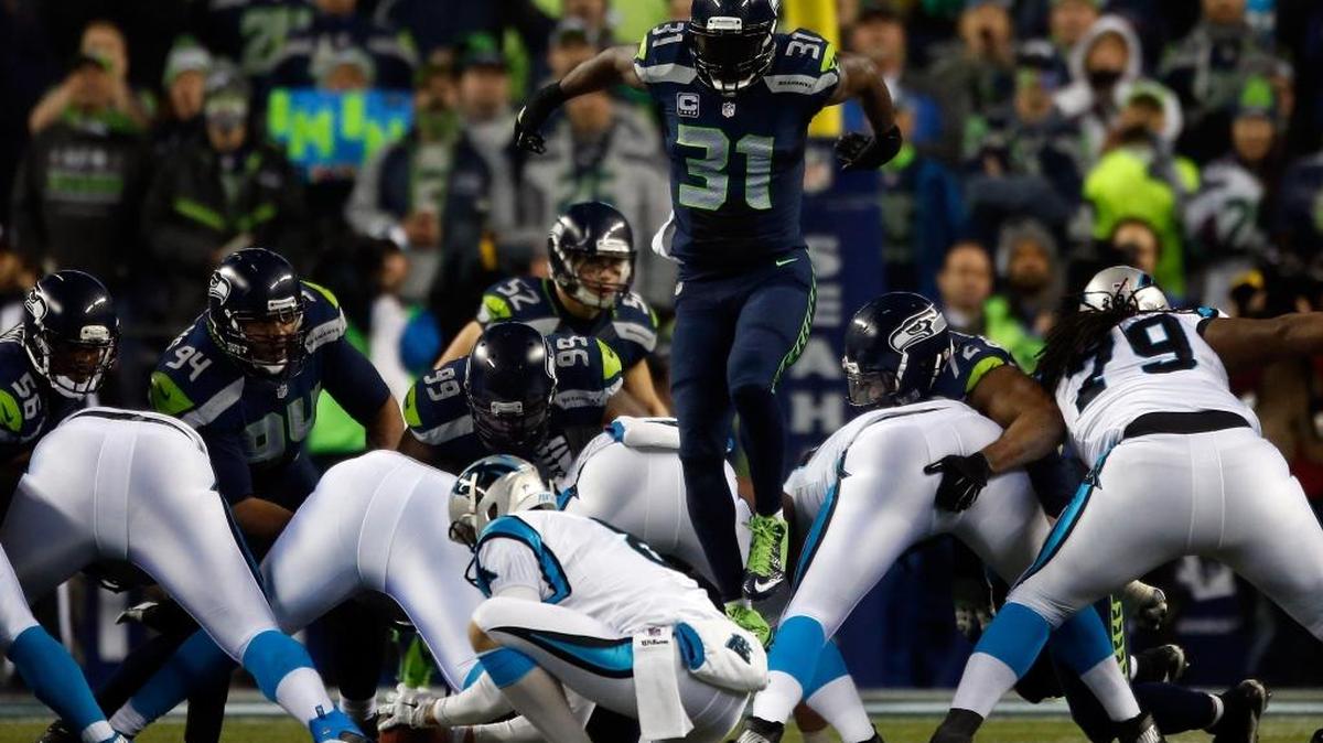 
Kam Chancellor (31) of the Seattle Seahawks leaped over the Panthers line on consecutive plays in a January playoff game, but was it illegal?
