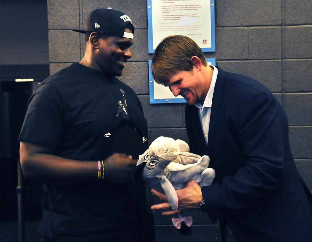 Feb. 26, 2014: Offensive tackle Jordan Gross (right), with Gettleman in attendance at his retirement ceremony, says he didn’t like Gettleman much after he was first hired (and asked Gross to take a pay cut).
