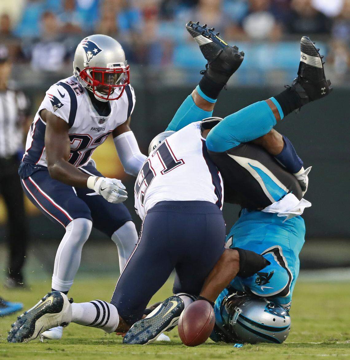 Carolina Panthers’ Cam Newton, right, fumbles the ball as he lands on his head after being hit by New England Patriots’ Deatrich Wise (91) during the first half of a preseason NFL football game in Charlotte, N.C., Friday, Aug. 24, 2018. The Panthers recovered the ball. (AP Photo/Jason E. Miczek)