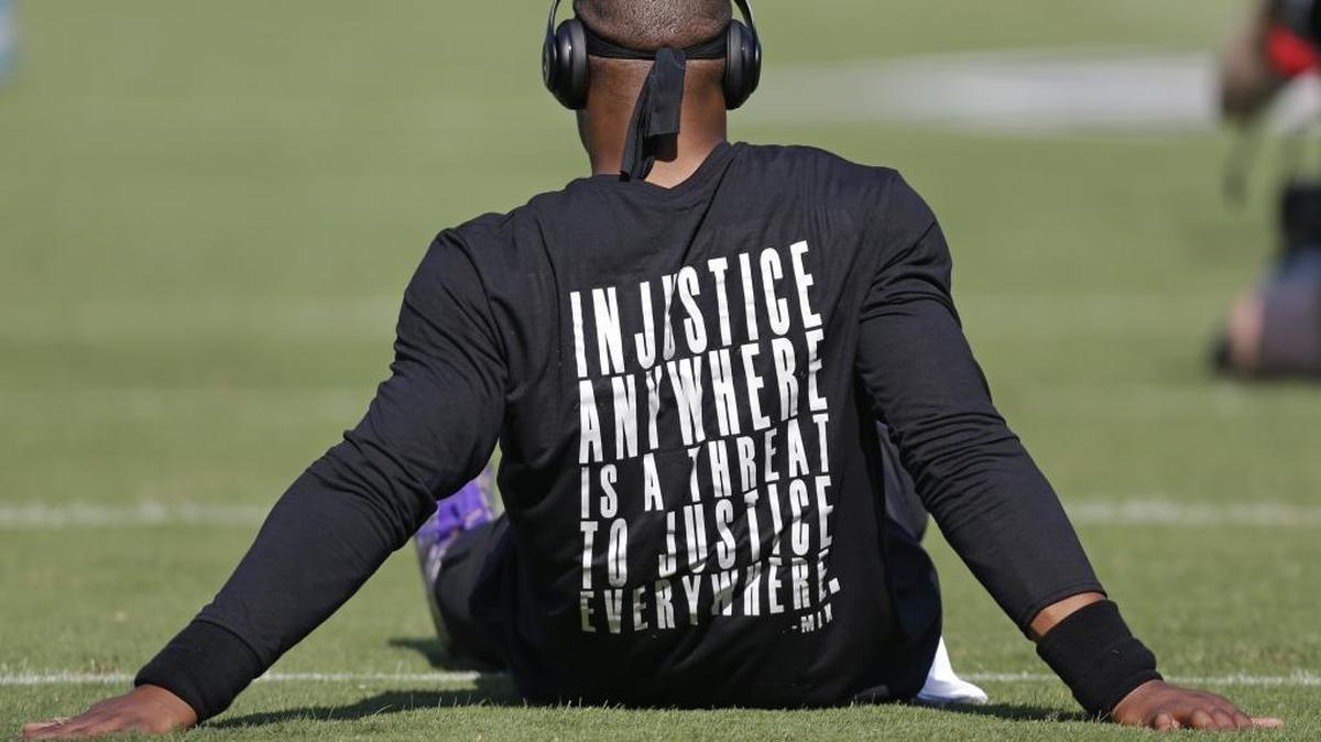 Carolina Panthers quarterback Cam Newton wears a shirt with a quote by Martin Luther King as he warms up before Sunday’s game against the Minnesota Vikings.