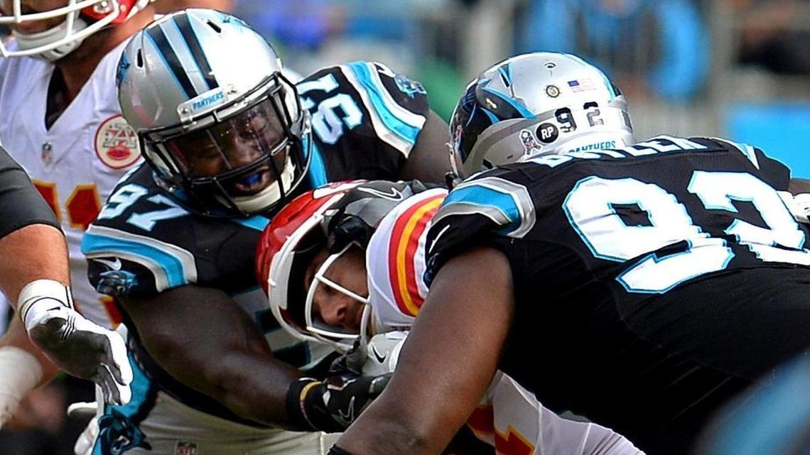Carolina Panthers defensive end Mario Addison, left, and defensive tackle Vernon Butler wrap up Kansas City Chiefs quarterback Alex Smith during the second quarter.