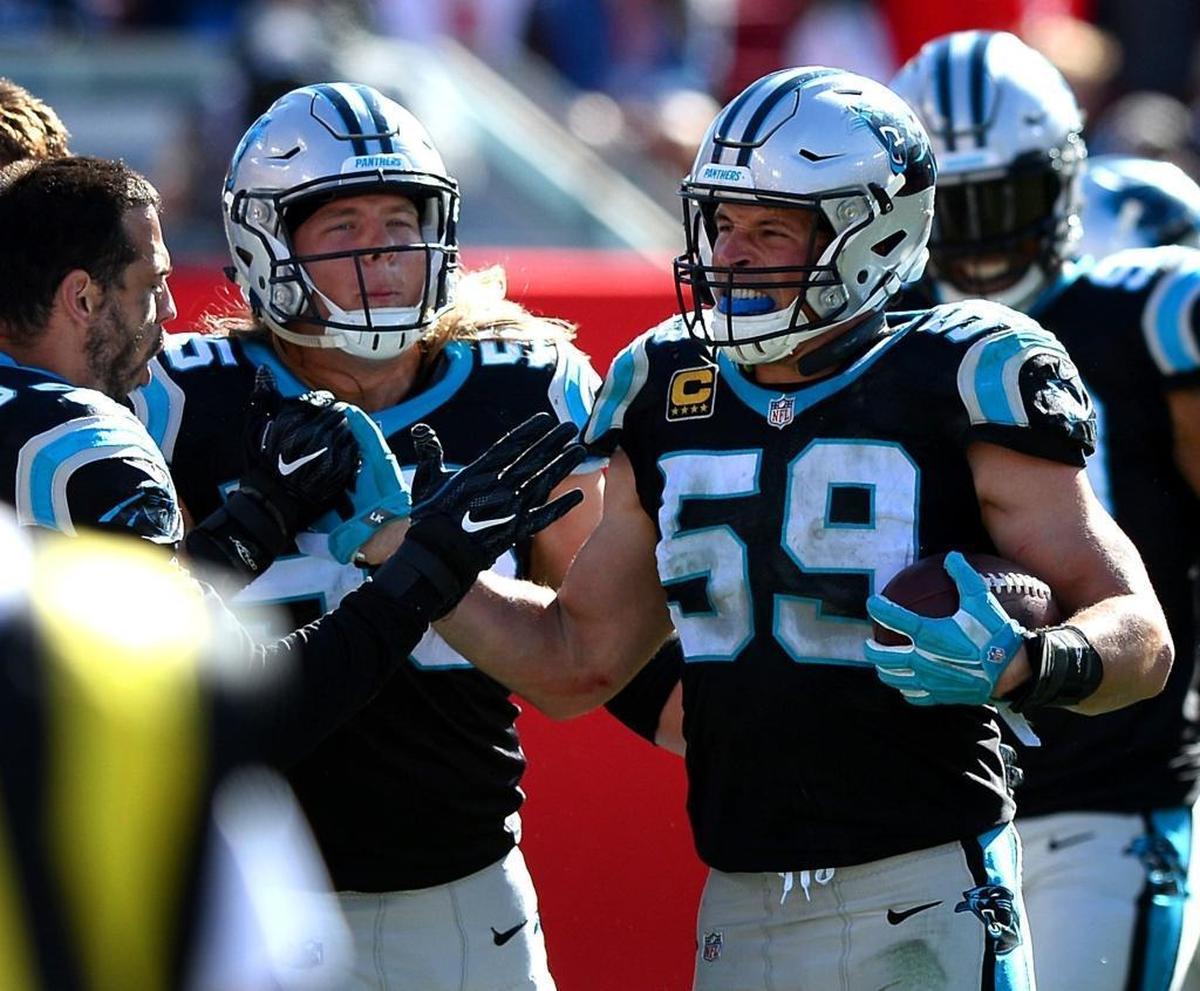 Carolina Panthers linebacker Luke Kuechly (59) is congratulated by his teammates after intercepting a pass by Tampa Bay Buccaneers quarterback Jameis Winston in the fourth quarter on Sunday.