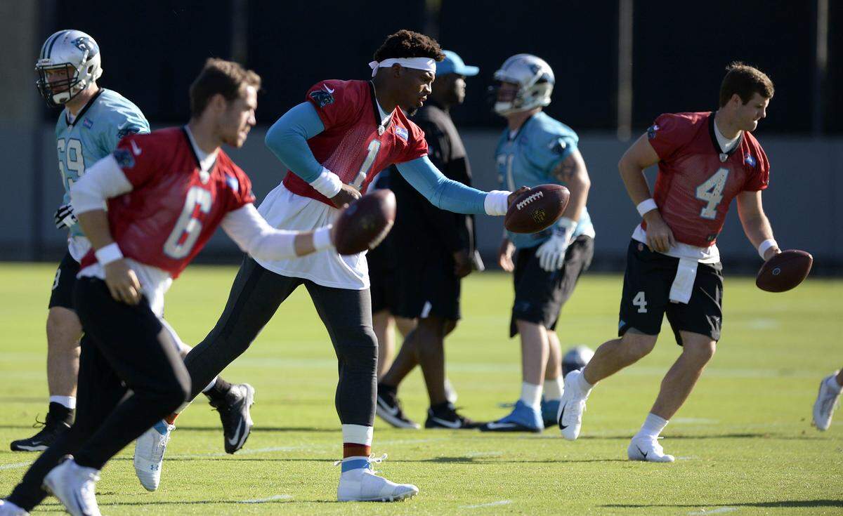 Carolina Panthers quarterback Cam Newton (1), quarterback Taylor Heinicke (6) and quarterback Garrett Gilbert (4) run a drill on the practice field during organized team activities on Monday, June 4, 2018.