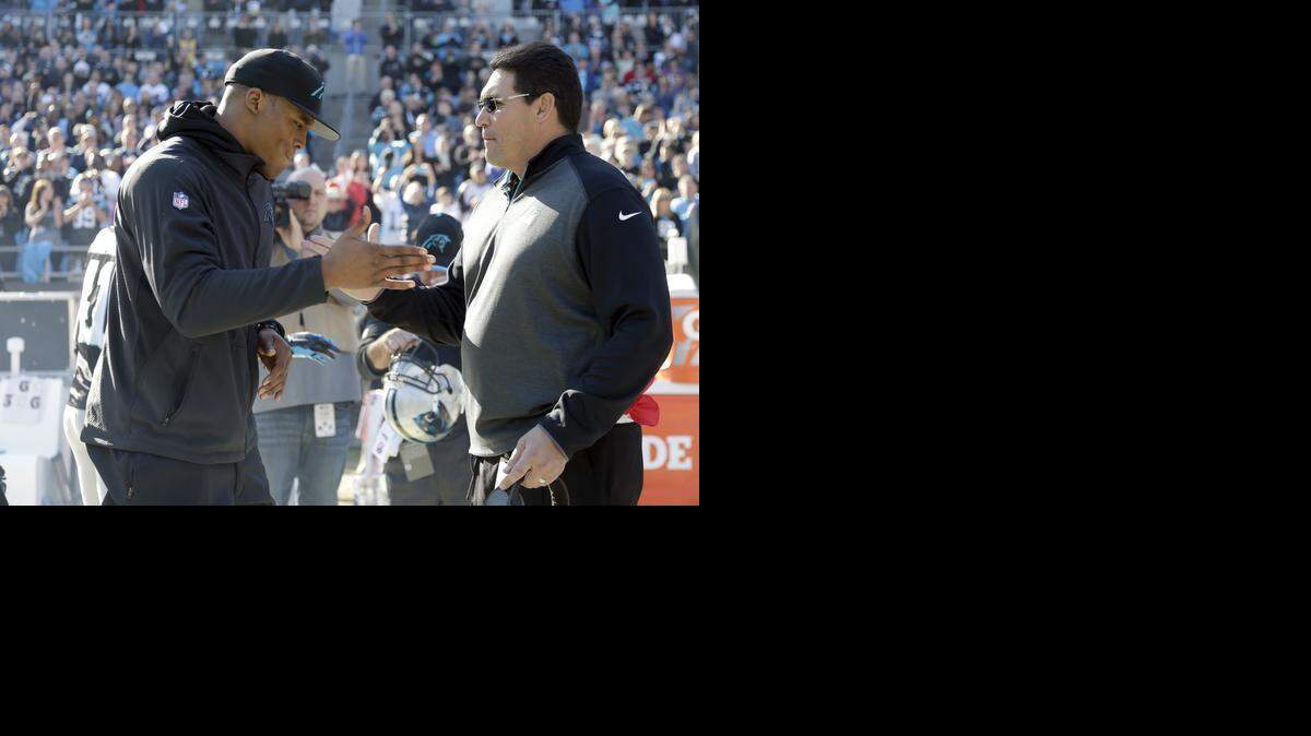 
Carolina Panthers quarterback Cam Newton shakes hands with his coach Ron Rivera before an NFL football game against the Tampa Bay Buccaneers in Charlotte, on Dec. 14. Newton missed the game after a car accident left him with broken bones in his back. 
