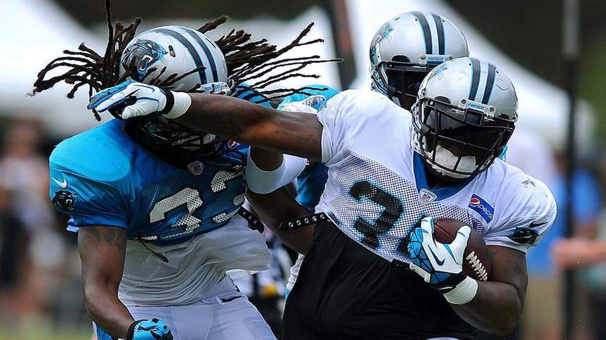 
Carolina Panthers full back Mike Tolbert breaks down a sideline following a pass reception as safety Tre Boston looks to make the stop during practice on Wednesday.
