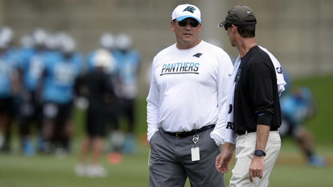 Carolina Panthers coach Ron Rivera, left, and athletic trainer Ryan Vermillion chat during Monday’s practice.