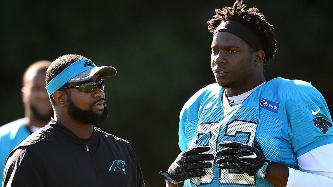 Carolina Panthers defensive line coach Sam Mills III, left, will have added “game management” responsibilities in 2019.