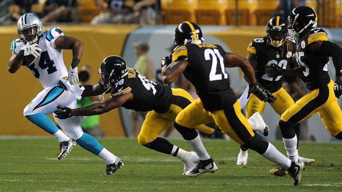 Carolina Panthers running back Cameron Artis-Payne, left, breaks to the outside in the first quarter against the Steelers in Pittsburgh, on Thursday.