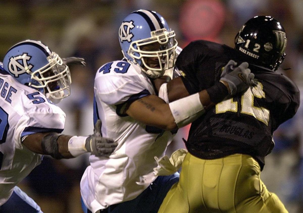 When he was at North Carolina, Panthers defensive end Julius Peppers (49) was already terrorizing Detroit Lions coach Jim Caldwell, who was then head coach at Wake Forest.