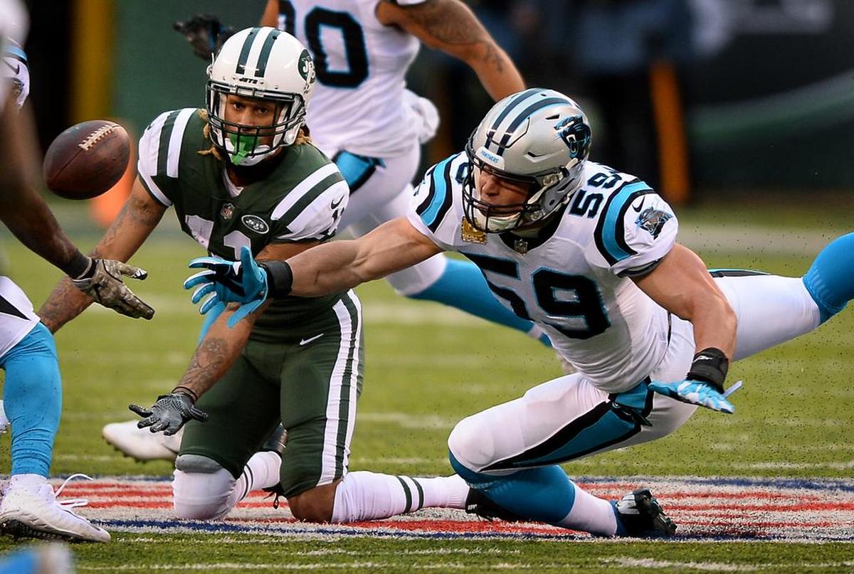 In a 2017 game, Carolina Panthers linebacker Luke Kuechly, right, tried to intercept a pass intended for New York Jets wide receiver Robby Anderson. Anderson joined the Panthers in March as a receiver and previously teamed with new Carolina coach Matt Rhule at Temple.