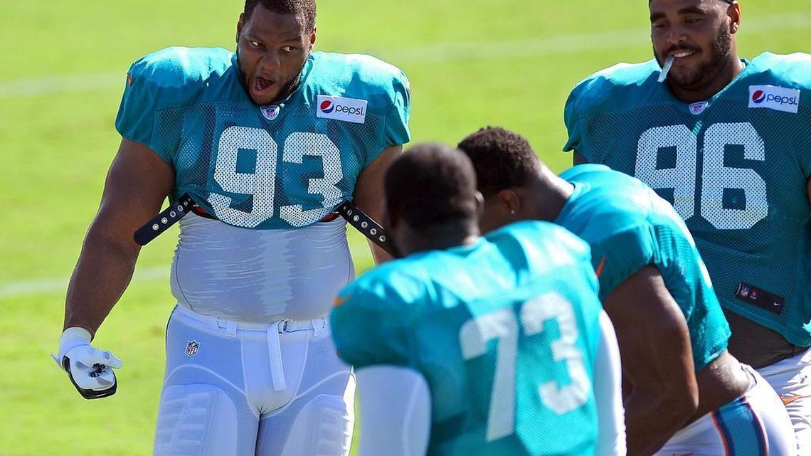 
Miami Dolphins defensive tackle Ndamukong Suh, left, jokes with his teammates during a water break at practice on Thursday. 
