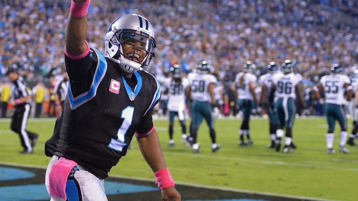 Carolina Panthers quarterback Cam Newton smiles as he celebrates full back Mike Tolbert's touchdown run vs the Philadelphia Eagles during first-quarter action at Bank of America Stadium in Charlotte on Sunday.
