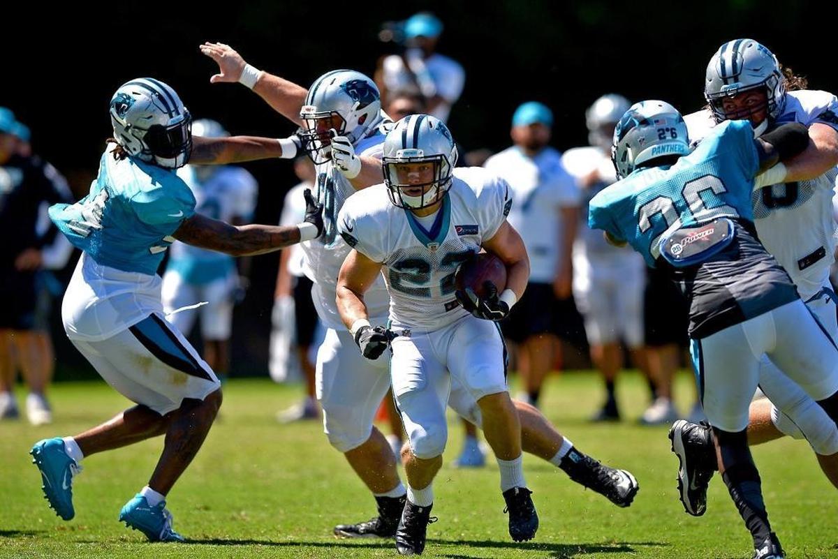 Carolina Panthers running back Christian McCaffrey, center, breaks up the middle on a run during practice on Sunday, July 30, 2017 at Wofford College in Spartanburg, SC.