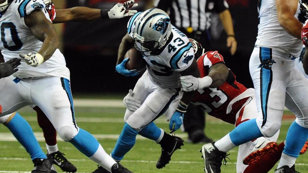 Carolina Panthers running back Fozzy Whittaker (43) gets tackles by Atlanta Falcons linebacker LaRoy Reynolds (53) during the second half at the Georgia Dome in Atlanta on Sunday. Atlanta won 48-33.