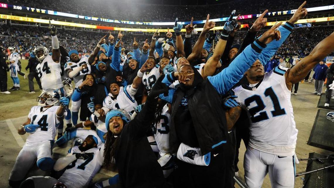 Members of the Carolina Panthers point to the stands near the end of the NFC Championship game against the Arizona Cardinals on Sunday, January 24, 2016.