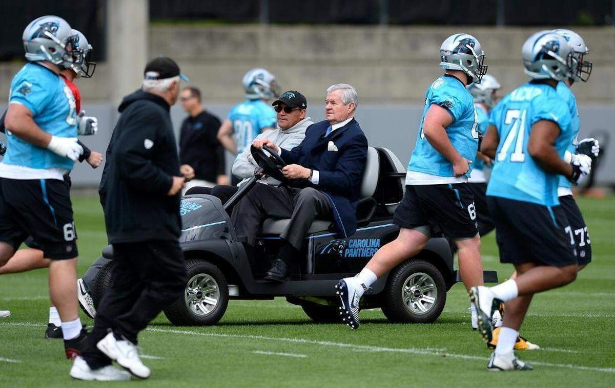 Carolina Panthers owner Jerry Richardson, center, drives head coach Ron Rivera on a golf cart during a May 2017 Panthers practice. Richardson has been the Panthers’ owner since the team played its first game in 1995.