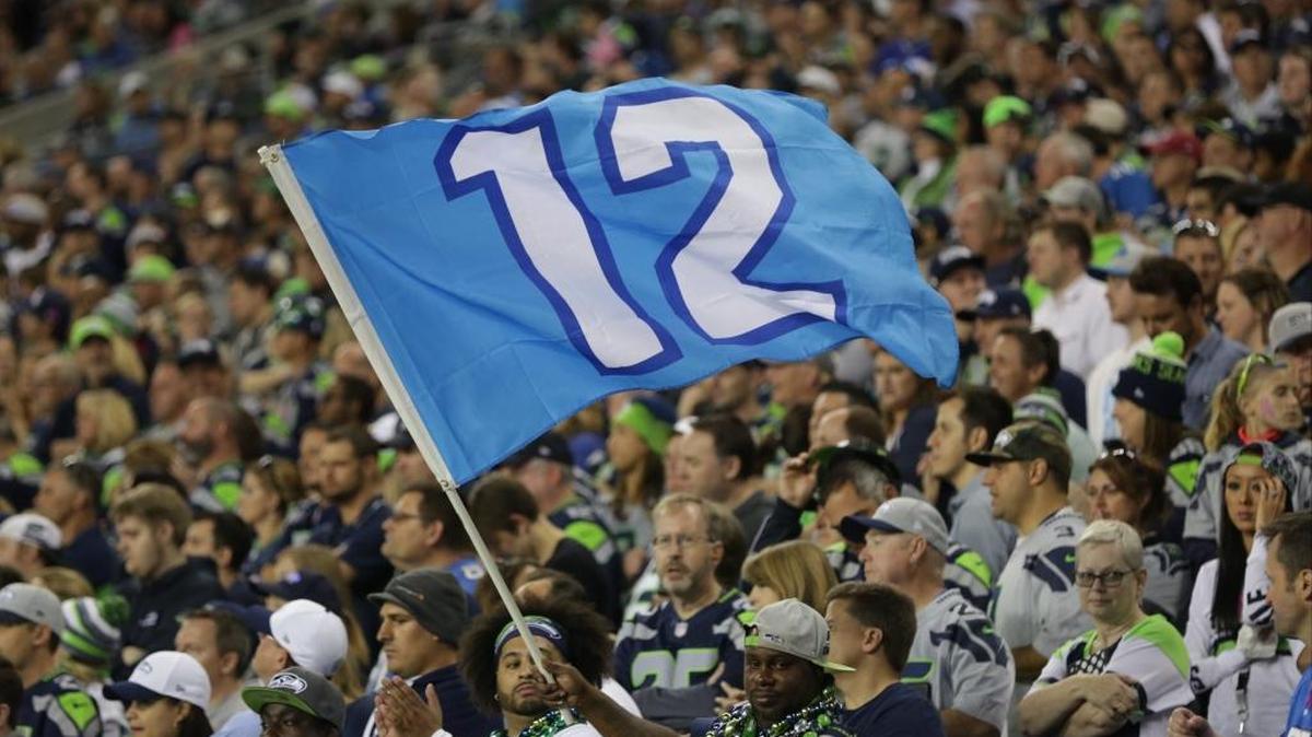 A fan waves a Seattle Seahawks 12th Man flag that wouldn’t meet the Carolina Panthers’ rules on banner size, which were tweaked this season.
