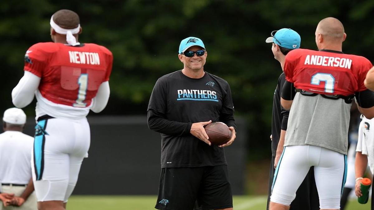 Carolina Panthers offensive coordinator Mike Shula, center, laughs as quarterbacks Cam Newton, left and Derek Anderson, right, warm up during practice at Wofford in Spartanburg recently. Shula says he is still bothered by the offense’s struggles at the Super Bowl in February.