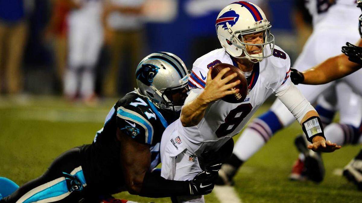 
Carolina Panther Rakim Cox (77) sacks the Buffalo Bills' Matt Simms (8) in the fourth quarter of their preseason game at Ralph Wilson Stadium on Friday.
