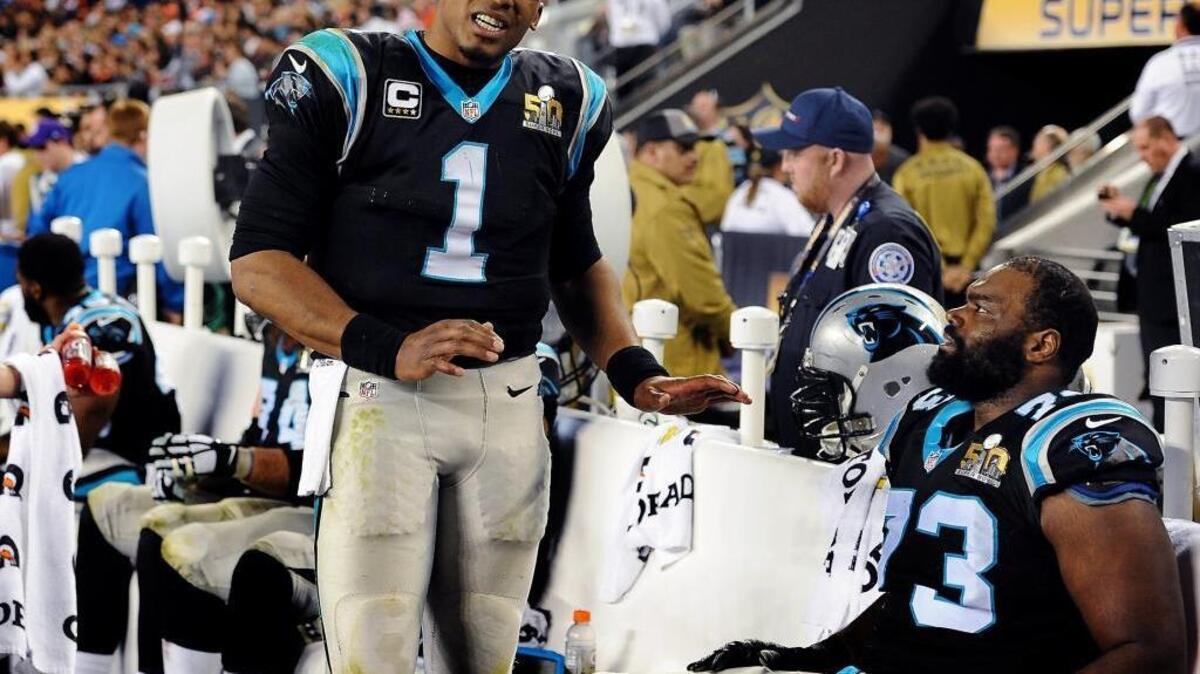 Carolina Panthers quarterback Cam Newton, left, talks to left tackle Michael Oher, right, during fourth quarter action vs the Denver Broncos at Levi's Stadium during Super Bowl 50. Michael Oher’s status remains in question.