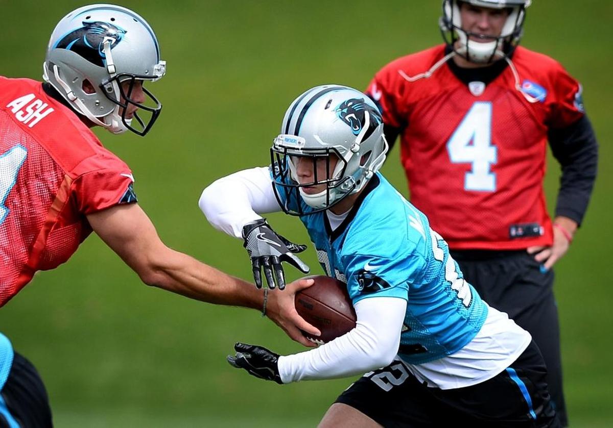 Carolina Panthers rookie running back Christian McCaffrey, right, takes a handoff during the second session of the team's rookie minicamp on May 5. McCaffrey missed OTAs because of an NCAA and NFL rule but will be present at minicamp starting Wednesday.