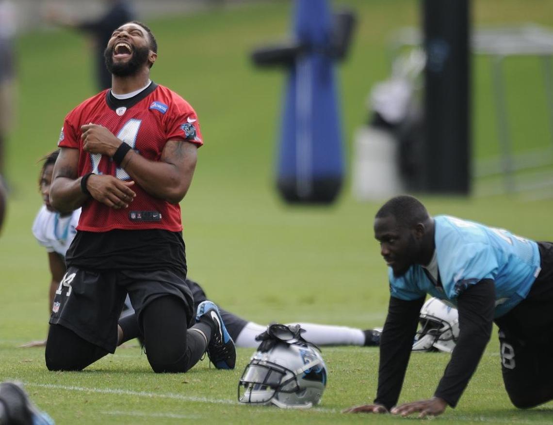 Carolina Panthers quarterback Joe Webb (14) sings along to the music during stretches on the last day of mini-camp.