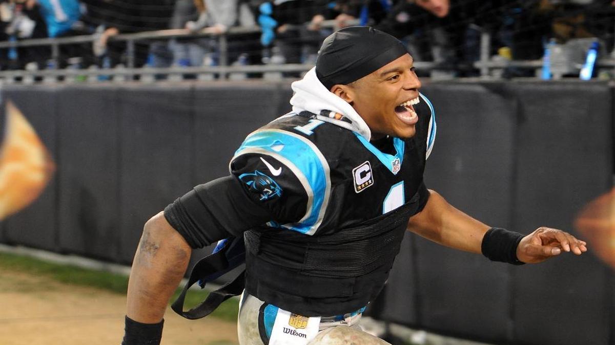 Carolina Panthers quarterback Cam Newton runs along the stands to slap hands with fans following the team's victory over the Tampa Bay Buccaneers 38-10 on Sunday.