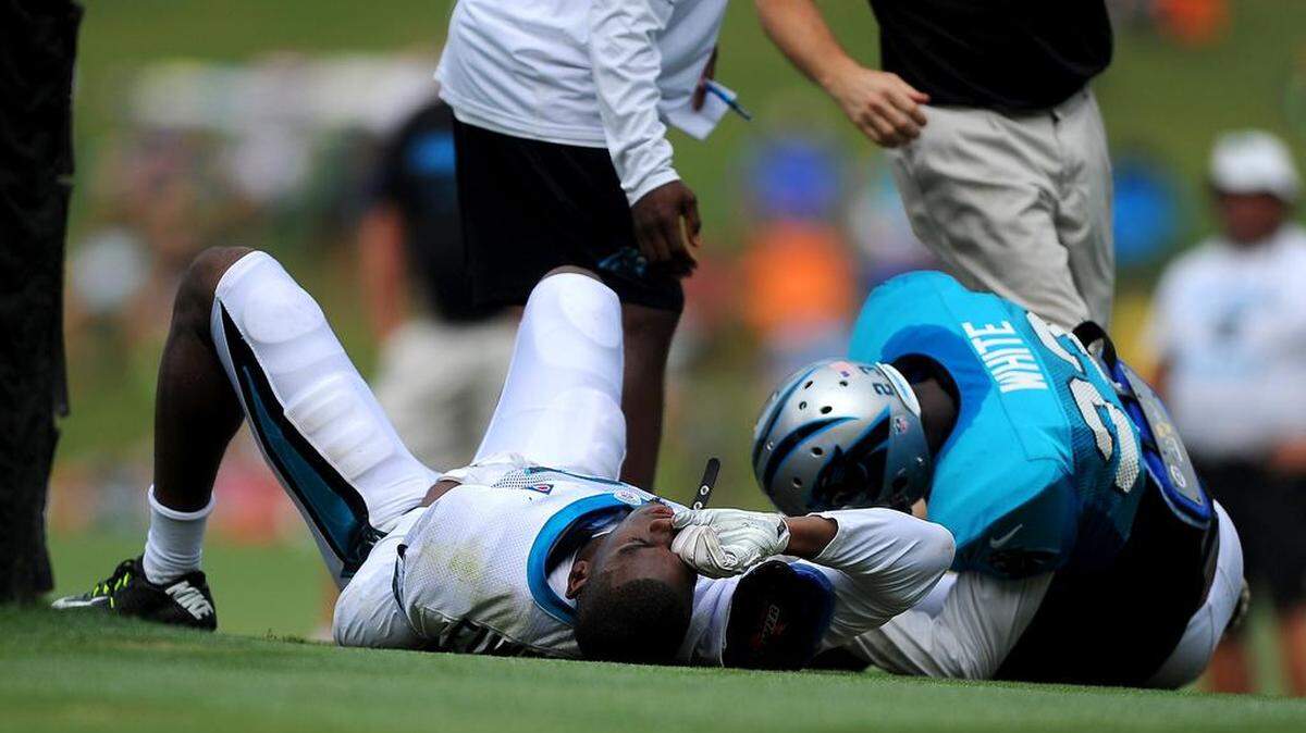 
A tanlge with cornerback Melvin White earned Carolina Panthers wide receiver Devin Funchess, left, a hard trip to the ground and a visit from trainer Ryan Vermillion to examine his sore shoulder. 
