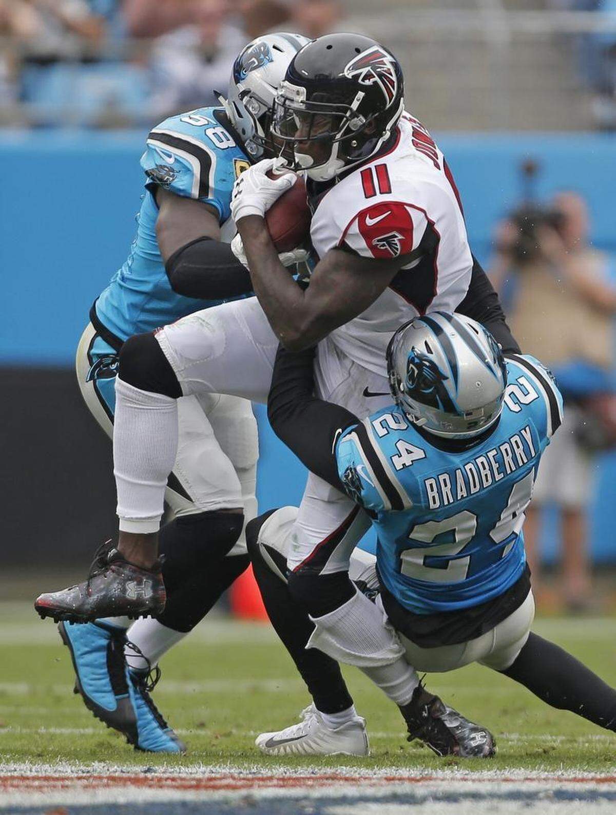The Atlanta Falcons tested Carolina’s secondary early courtesy of Julio Jones (11). Above, Panthers defenders James Bradberry (24) and Thomas Davis (58) bring down Jones in the first half of Sunday’s game.