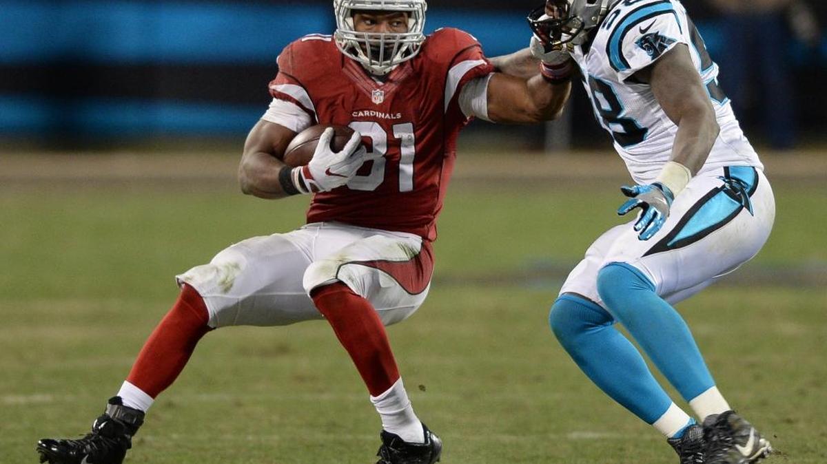 Cardinals David Johnson is stopped by Thomas Davis in the second quarter of Sunday’s NFC Championship in Charlotte.