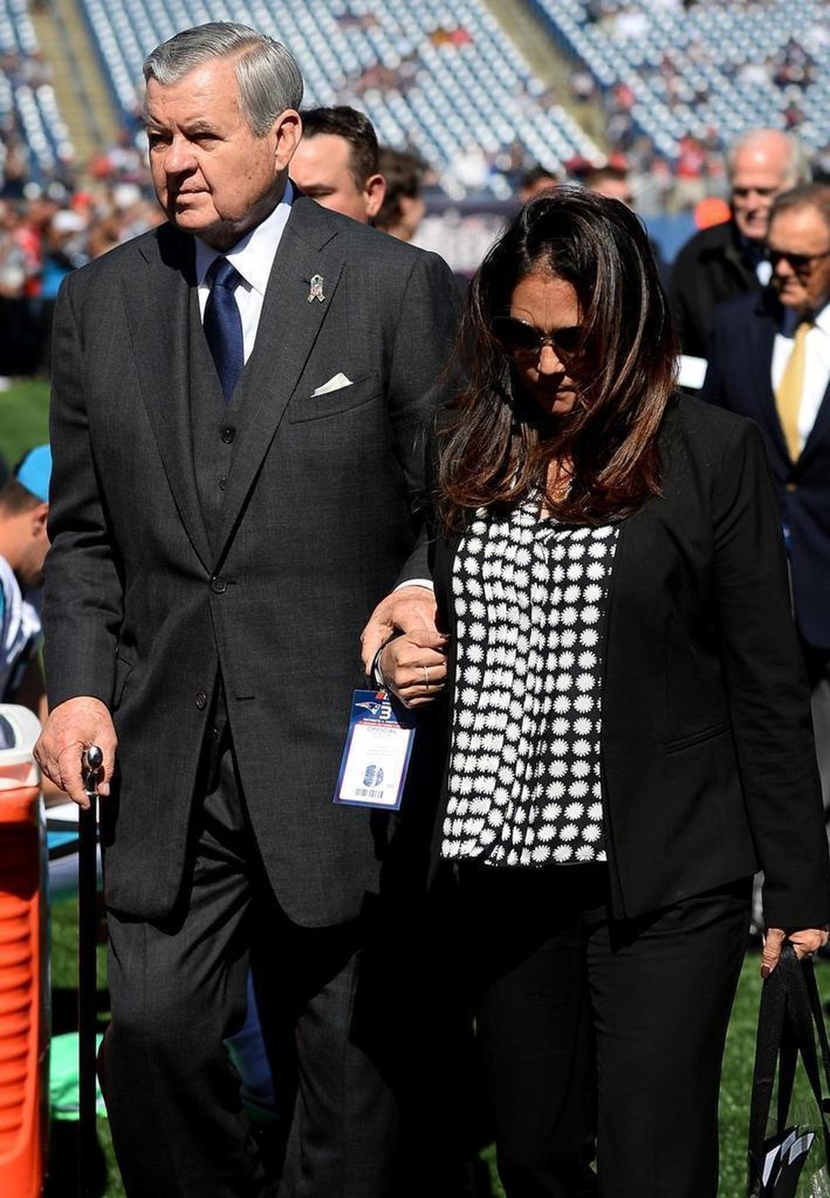 Tina Becker, right, assists Carolina Panthers owner Jerry Richardson, left, back to a golf cart along the sidelines at Gillette Stadium in Foxborough, Mass. on Sunday, October 1, 2017. The Carolina Panthers announced on Monday, December 18, 2017 that Tina Becker, center, has been named chief operating officer with full control of the day-to-day management of the organization.