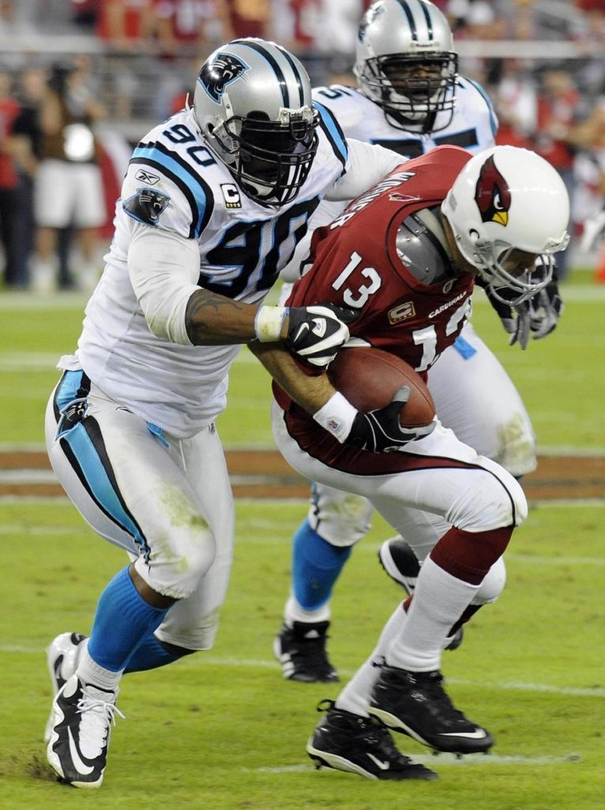 Carolina Panthers defensive end Julius Peppers (90) sacks Arizona Cardinals quarterback Kurt Warner (13), who fumbled on the play and the Panthers recovered.