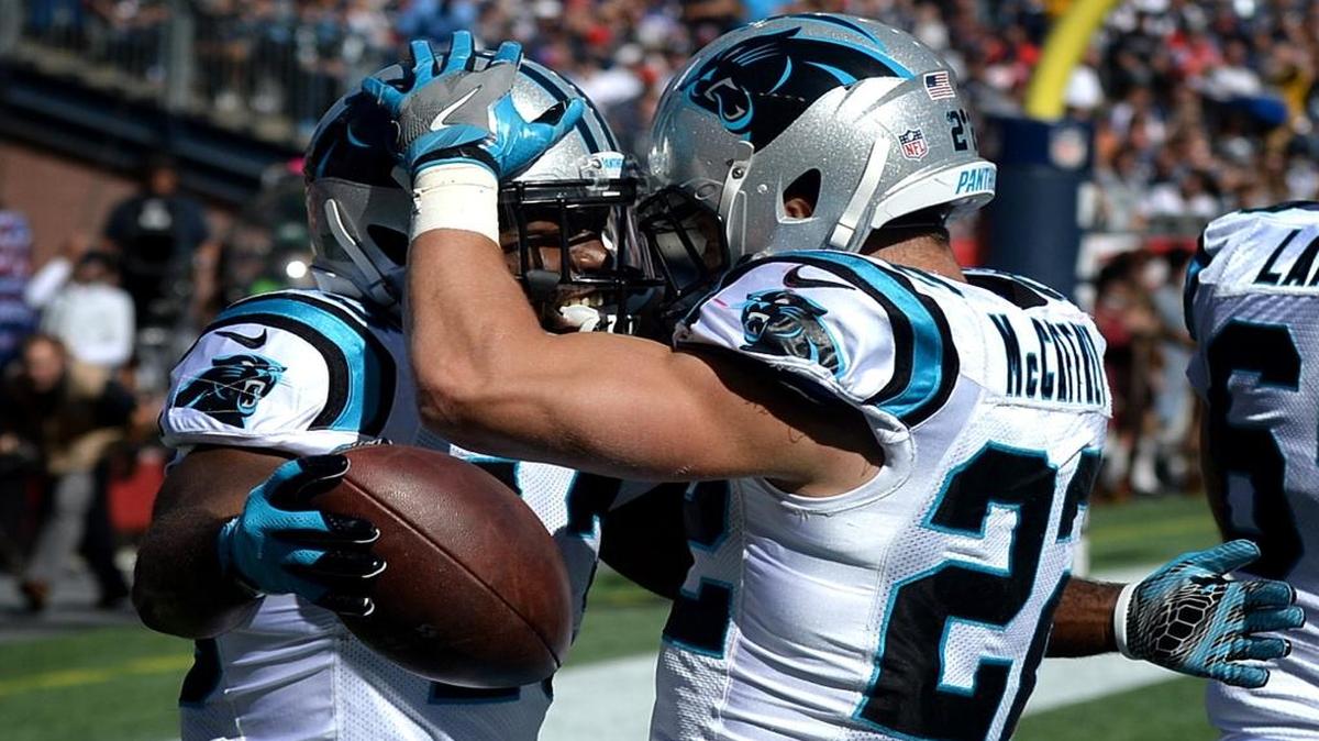 Carolina Panthers running back Fozzy Whittaker, left, is congratulated by running back Christian McCaffrey, right, after Whittaker scored a touchdown against the New England Patriots in the second quarter on Sunday.