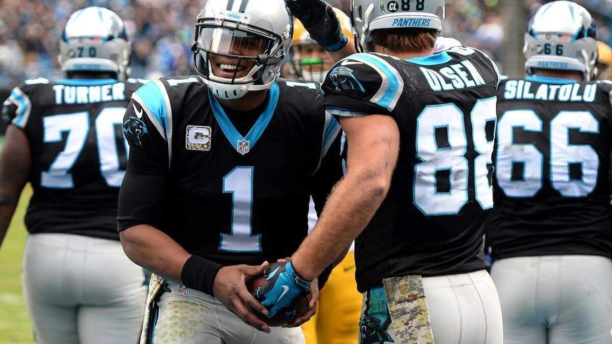Carolina Panthers quarterback Cam Newton, left, threw three touchdown passes, including one to tight end Greg Olsen, but admitted afterPanthers defeated the Packers 37-29 that he left points on the field.
