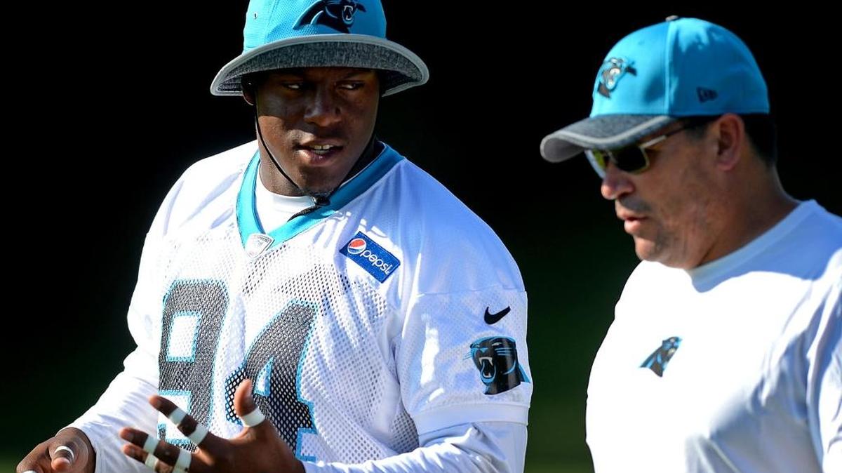 Carolina Panthers defensive end Kony Ealy, left, speaks with head coach Ron Rivera as they walk to practice at Wofford College on Sunday, July 31, 2016 in Spartanburg, S.C.