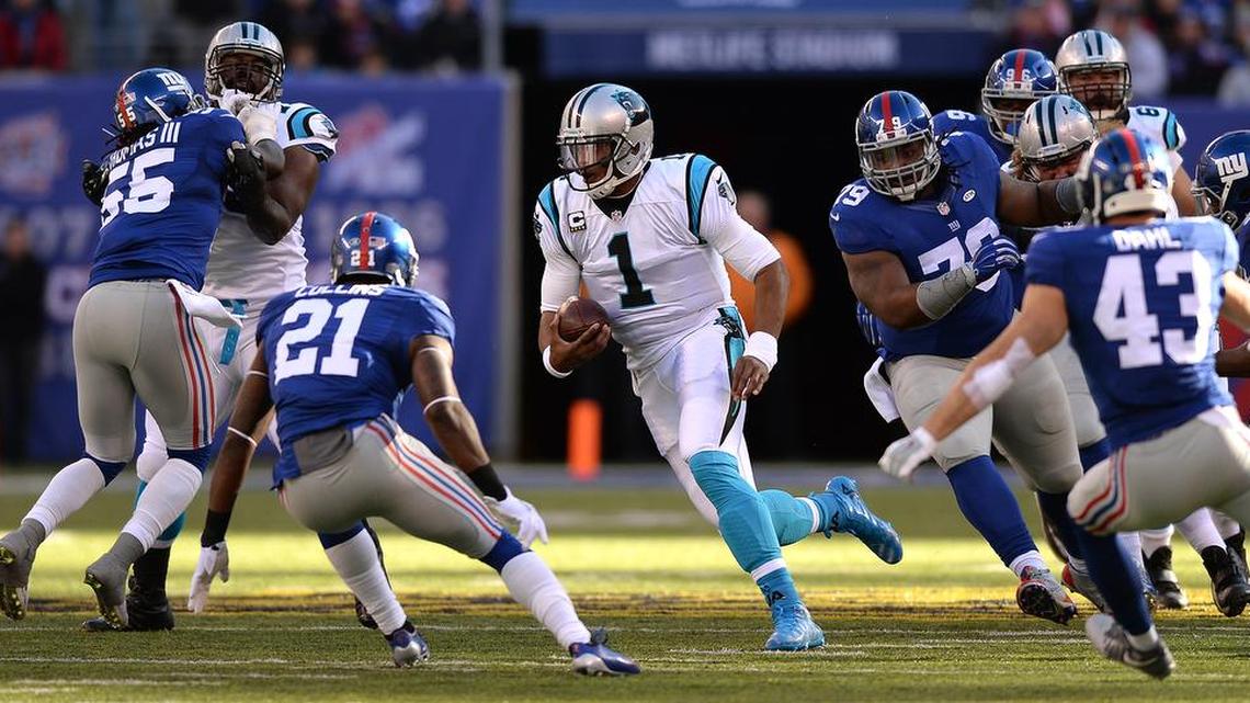 Carolina Panthers quarterback Cam Newton breaks into a hole for yardage during Sunday’s game. The Panthers defeated the Giants 38-35.