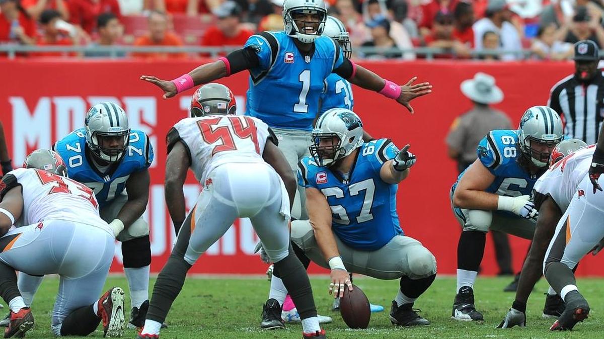 
Carolina Panthers quarterback Cam Newton smiles as he stands over the line prior to the snap vs the Tampa Bay Buccaneers during second quarter action on Sunday, October 4, 2015 at Raymond James Stadium in Tampa, Fl. The Panthers defeated the Buccaneers 37-23. 
