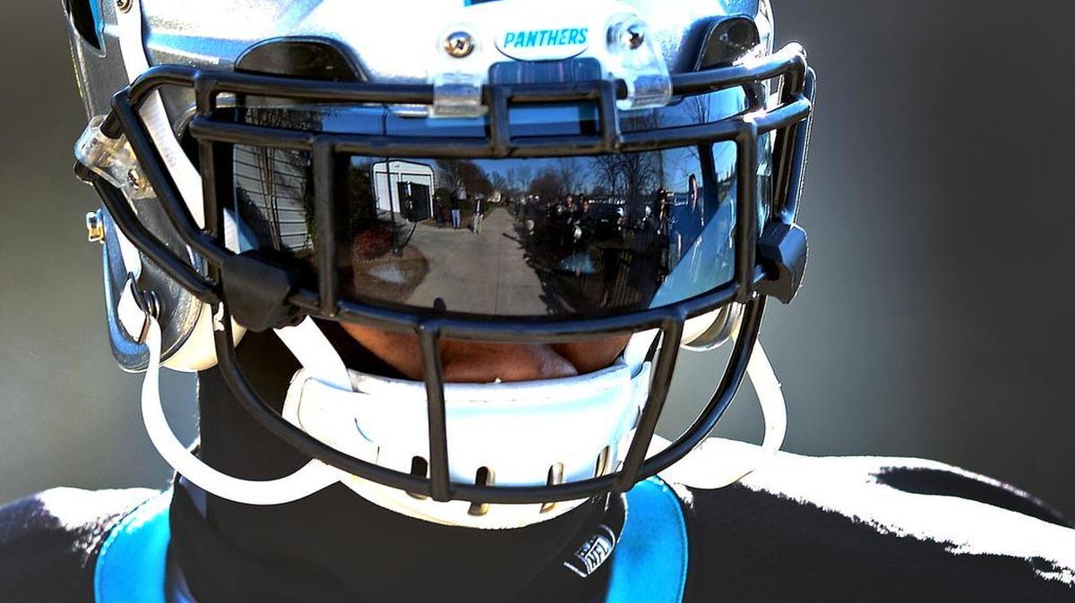 Carolina Panthers cornerback Josh Norman glances over at fans along a fence as he walks to practice on Thursday, January 14, 2016.