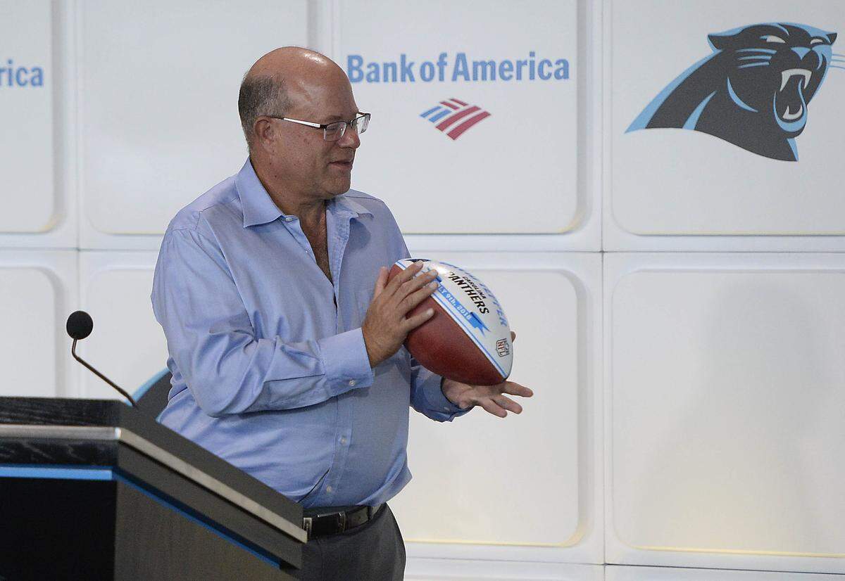 Billionaire hedge-fund manager David Tepper, the new owner of the Carolina Panthers, catches a ceremonial ball tossed to him at the conclusion of his introductory press conference at Bank of America Stadium on Tuesday, July 10, 2018.