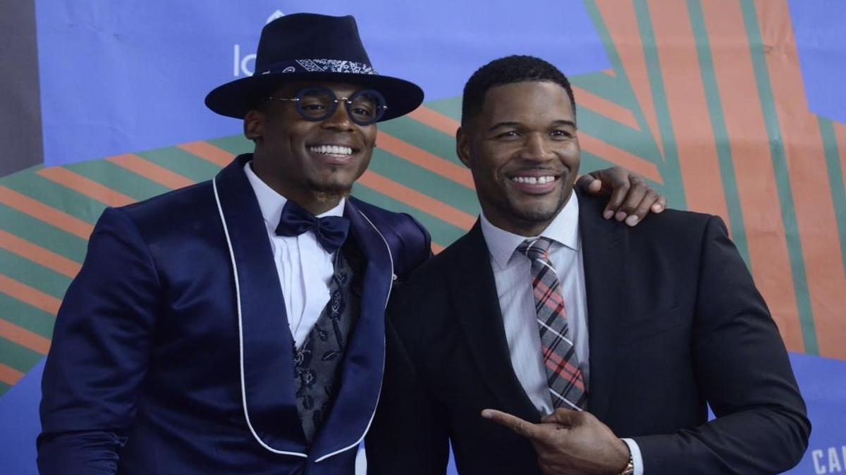 Carolina Panthers quarterback Cam Newton poses for a photo with retired New York Giants defensive end Michael Strahan at the Cam Newton Foundation’s “Kids Rock!” gala in the Charlotte Convention Center in June. Strahan played host along with Young Dylan, a kid rapping sensation.