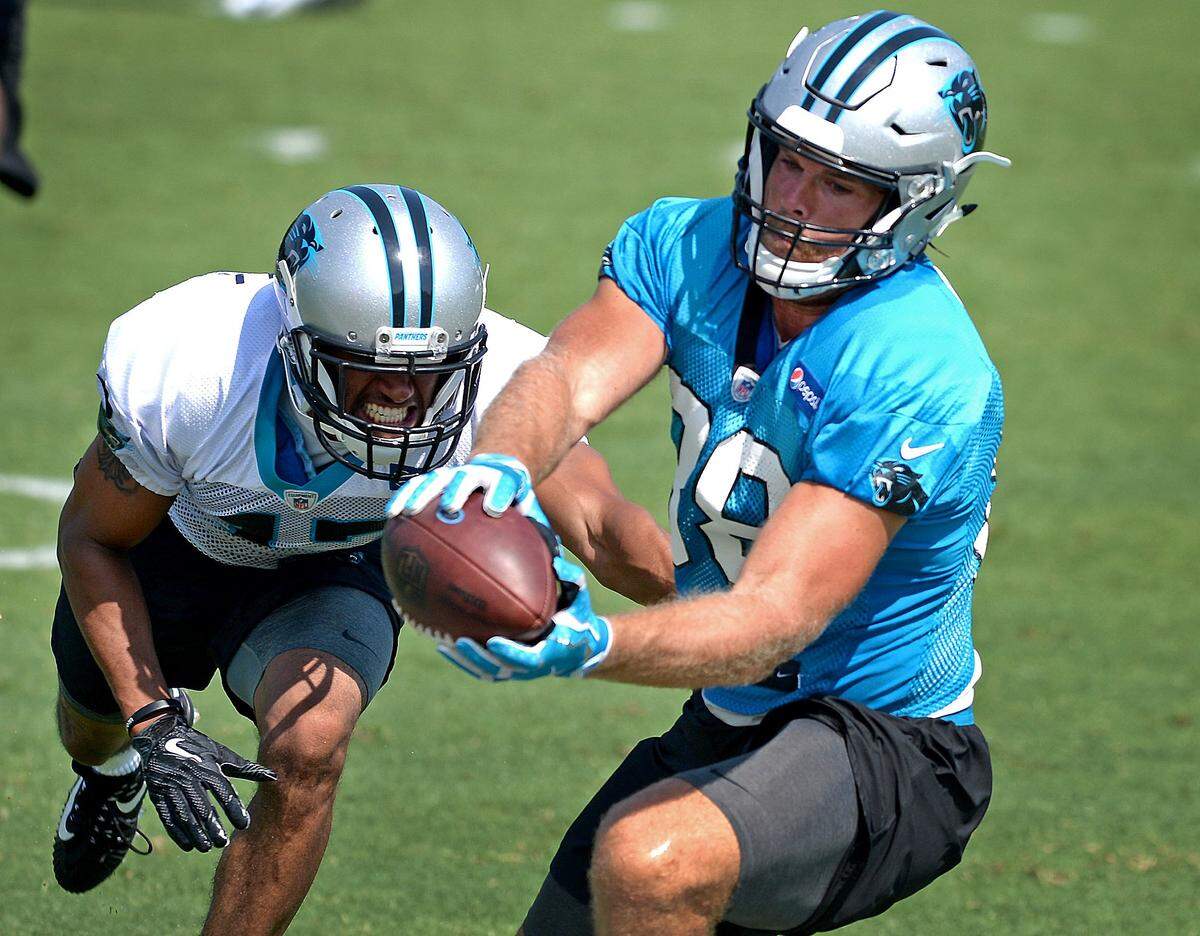 Carolina Panthers tight end Greg Olsen, right, catches a pass along the sideline as cornerback Ross Cockrell, left, looks to make the stop during the team’s second training camp practice on Friday, July 27, 2018. The Panthers are holding training camp at Wofford College in Spartanburg, SC.