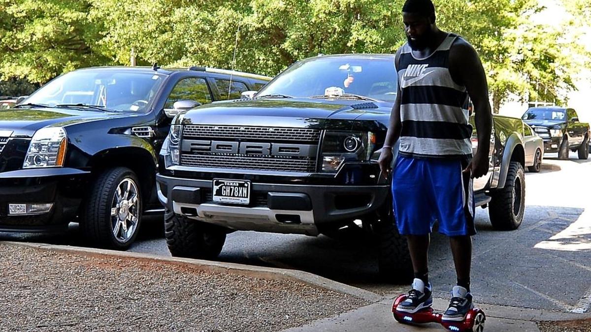 Carolina Panthers defensive end Mario Addison rides a hoverboard at training camp in Spartanburg. Coach Ron Rivera has now banned the boards from the team’s facilities.